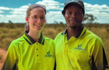 iScape NT team members standing outdoors in the Northern Territory wearing high-visibility green uniforms.